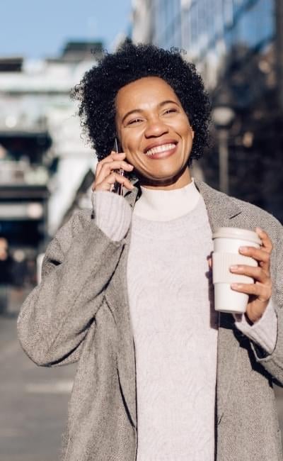 smiling woman walking on a city street